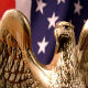 bronze bald eagle statue in front of the American flag